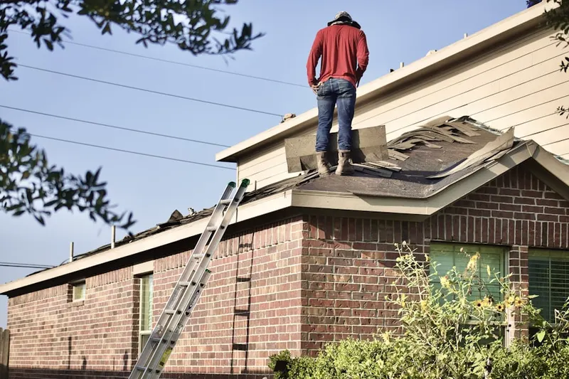 Professional roofer working on a residential roof in Woodley Hills